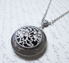 The antique silver plated floral engraved locket is 32mm. An antique silver Renaissance style pattern adorns the front of this locket. The locket is connected to a 24 inch chain by a rosary style connector. The locket is packaged in a lovely little silhouette box, set on a soft piece of white cotton. ♥ * ♥ * ♥ * ♥ * ♥ * ♥ * ♥ * ♥ © Original design by Twilight's Castle Thank you for visiting! Twilight's Castle Antique Silver Vintage Charm Locket Necklace, Antique Silver Locket Necklace For Vintage Collection, Vintage Silver Locket Necklace With Round Pendant, Vintage Antique Silver Locket Necklace Nickel Free, Antique Silver Locket Necklace Nickel Free, Silver Medallion Locket Necklace With Vintage Charm, Vintage Nickel Free Antique Silver Locket Necklace, Silver Vintage Locket Necklace With Round Pendant, Vintage Antique Silver Nickel-free Locket Necklace