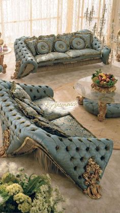 an ornately decorated living room with blue couches