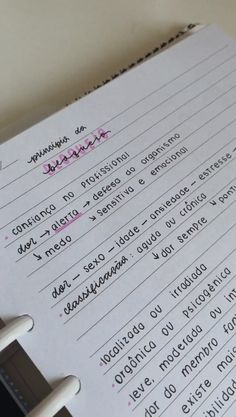 a close up of a notebook with writing on it