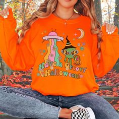 Get ready for the spooky season with this Retro Alien Trick-or-Treat Sweatshirt! Slip into this sweatshirt, embrace the nostalgia, and get ready to trick-or-treat across the galaxy in style! Makes a great Halloween Party Shirt or gift. *Shirt colors may appear slightly different on different computer screens. We strive our best to give you the most accurate pictures of shirt colors. We apologize if they look slightly different in real life. This sweatshirt fits like a normal unisex sweatshirt, s Retro Long Sleeve Halloween Tops, Halloween Horror Long Sleeve T-shirt, Horror Long Sleeve Sweatshirt For Halloween, Fall Costume Party Crew Neck Top, Fall Crew Neck T-shirt For Costume Party, Fall Crew Neck Top For Costume Party, Crew Neck Tops For Costume Party In Fall, Halloween Graphic Print Sweatshirt, Funny Halloween Graphic Print Sweatshirt