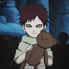 a boy holding a teddy bear in his arms