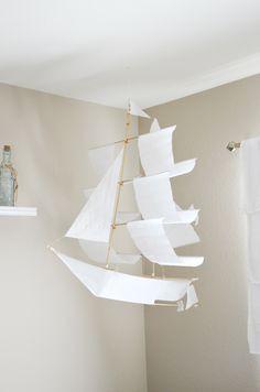 a model sailboat hanging from the ceiling