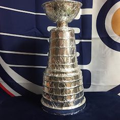 a silver trophy sitting on top of a blue table