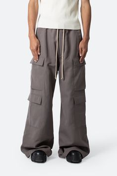 the Rave Double Cargo Pants are designed with a new oversized rave fit, constructed from a polyester fabric with a rinse wash, contrast drawcord, and finished with cargo pockets throughout.  details ultra baggy fit throughout 100% polyester extended inseam model is 6’1, 140 lbs and wears a size 30 Brown Pants Men, Rave Fit, Dusty Brown, 140 Lbs, Streetwear Essentials, Suede Pants, Slim Denim, Ripstop Fabric, Cargo Pocket