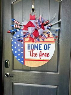 a patriotic door hanger that says home of the free