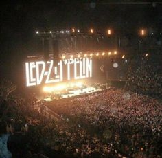 a large crowd at a concert with the word led - zitton lit up