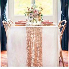 the table is set with pink and white flowers