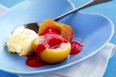 a blue plate topped with fruit and ice cream on top of a blue table cloth