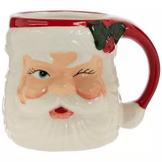 a ceramic mug with a santa face on it