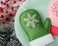 two green mittens sitting on top of a white plate