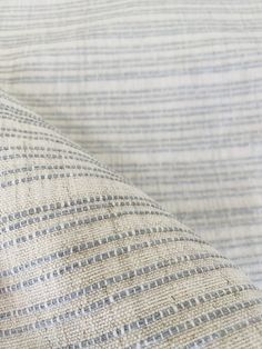 a close up view of a white and blue striped fabric