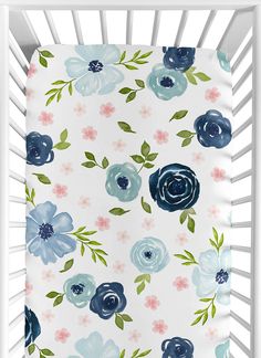 a white crib with blue and pink flowers on it