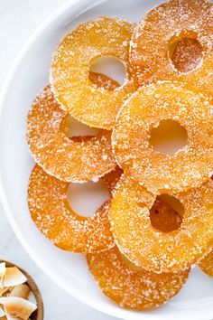 a white plate topped with donuts covered in sugar