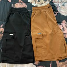 Two Pair Of Never Worn Men’s Cargo Shorts. Black And Copper Both Are Size Medium Casual Brown Shorts With Side Pockets, Black Cargo Style Shorts, Brown Streetwear Shorts With Pockets, Brown Pocketed Shorts For Streetwear, Brown Shorts With Pockets For Streetwear, Brown Cotton Shorts For Streetwear, Brown Streetwear Shorts, Brown Cargo Shorts With Cargo Pockets, Black Cargo Style Short Bottoms