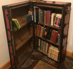 an open book case sitting on the floor in front of a wall with a clock