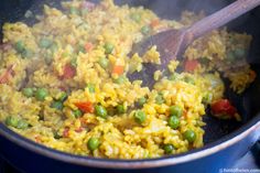 rice and peas are being cooked in a pot