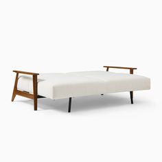 a white couch sitting on top of a wooden frame