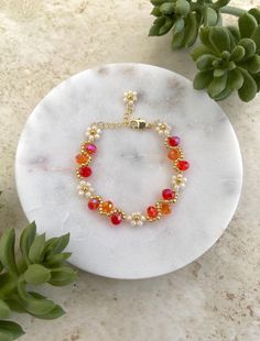 Meet our handmade Daisy Flower Bracelet in red ombre, with an elegant gold finish. It makes a great gift for many occasions such as birthdays, anniversaries, Christmas and more! Silver finish is also available in our shop. It is an adjustable bracelet from 6 inch to 7.5 inches in length which should fit most people comfortably. If you are looking for a specific length, please message us as we would love to make it for you! This fully handmade floral-themed bracelet features intricate designs usi Red Flower Bracelets For Valentine's Day, Gold Flower Beaded Bracelets For Party, Gold Floral Beaded Bracelets For Parties, Gold Flower-shaped Beaded Bracelets For Parties, Gold Flower Bracelets For Valentine's Day, Adjustable Red Flower Beaded Bracelet, Red Flower-shaped Beaded Bracelets For Jewelry Making, Red Flower Bracelets For Wedding, Elegant Red Flower Bracelets