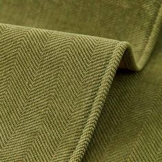 a close up view of the fabric on a green cloth with small, diagonal stripes