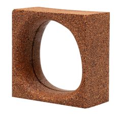 a square shaped object made out of brown rocks on a white background, with one section cut out and the other half partially closed