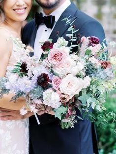 a bride and groom pose for a wedding photo