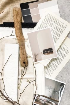 the table is covered with papers, pictures and an old wooden stick on top of it