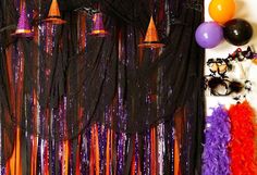 a party decoration with black, orange and purple streamers