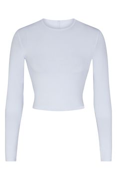 Specially washed for a vintage appearance, this long-sleeve top from Kim Kardashian's SKIMS is cropped to hit you at your natural waist. 17" regular length (size Medium) Crewneck Long sleeves 92% cotton, 8% spandex Machine wash, dry flat Imported White Fitted Crop Top With Cropped Hem, Fitted White Top With Cropped Hem, Fitted White Cropped Top, White Fitted Top With Cropped Hem, Fitted Cotton Cropped Sweater For Spring, Casual Long Sleeve Cropped T-shirt For Spring, Fitted Cropped Tops With Thumbholes, Basic Long Sleeve Crop Top, Fitted Long Sleeve Cotton Crop Top