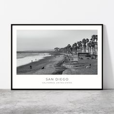 a black and white photo of people walking on the beach in san diego, california