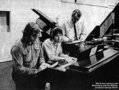 three people sitting at a piano playing music