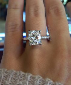 a woman's hand with a diamond ring on it