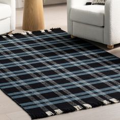 a black and white plaid rug in a living room