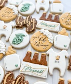 decorated cookies are arranged on a table for a baby shower or bridals party