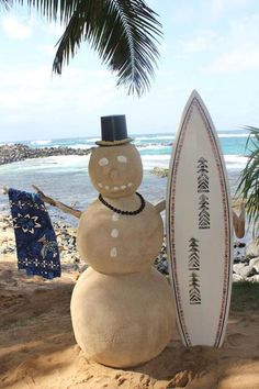 a snowman is standing next to a surfboard