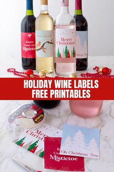 three bottles of wine sitting on top of a table next to christmas cards and bottle openers