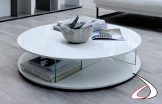 a white coffee table sitting on top of a hard wood floored living room area