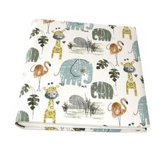 an elephant, giraffe and zebra print baby blanket on a white background with palm trees