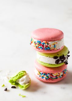 three colorful macaroons sitting on top of each other