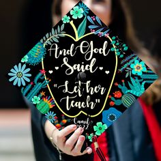 a woman wearing a graduation cap that says and god said it's the teacher