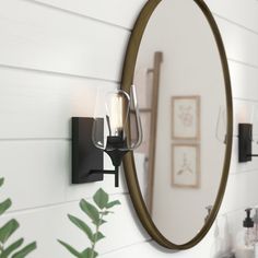 a bathroom mirror hanging on the wall next to a sink