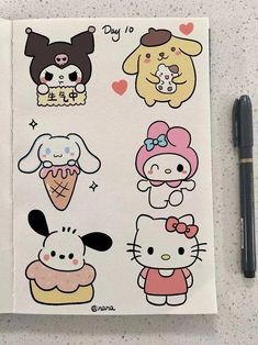 an open notebook with hello kitty stickers on the cover and a pen next to it