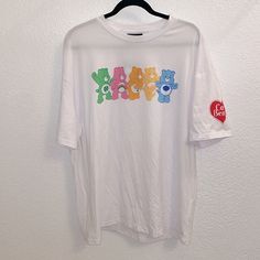 Care Bears X Romwe Collaboration White Short Sleeve Tee Shirt Colorful Care Bear Image On The Front Red Heart Care Bears Logo On Left Sleeve Never Worn, Nwt Size L P Casual White Print Short Sleeve Shirt, Casual Tops With White Funny Print, Cute White T-shirt For Streetwear, Fun White Top For Streetwear, Cute White Tops For Streetwear, Fun White Tops For Streetwear, Fun Printed Tops For Streetwear, Fun White Printed Tops, Casual White Printed Shirt