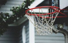 a basketball hoop hanging from the side of a house