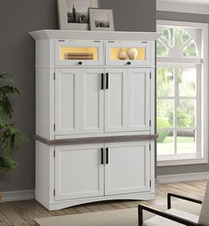 a white cabinet with two doors and drawers