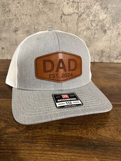 The perfect gift for any dad, can be customized to have any year or no year on the patch. This dad trucker hat is made with the highest quality hat (A Richardson 112), and a real leather dad patch hat. Perfect for a dad birthday gift or a new dad gift. This dad hat will not disappoint. The best dad gift is a personalized gift he can wear any day.  * If you are looking for a different style or color of hat, just send us a message. We have thousands of hats in stock, and can not list them all. In Outdoor Trucker Hat For Father's Day, Father's Day Gift Trucker Hat With Curved Brim, Father's Day Trucker Hat For Outdoor, Father's Day Outdoor Trucker Hat, Father's Day Trucker Hat In Baseball Cap Style, Father's Day Trucker Baseball Cap With Curved Brim, Father's Day Trucker Hat Baseball Cap, Personalized Hats For Father's Day, Father's Day Outdoor Trucker Hat With Curved Bill