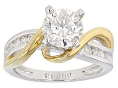 a white and yellow gold ring with a diamond