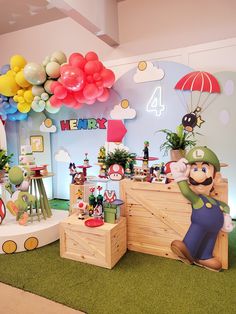 a mario birthday party with balloons and decorations on the wall, including an air balloon