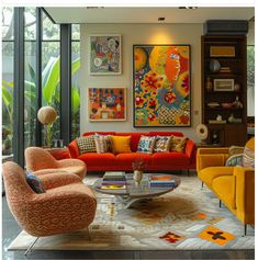 a living room filled with orange couches and colorful paintings on the wall above them