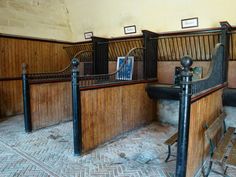 the inside of a building with benches and railings