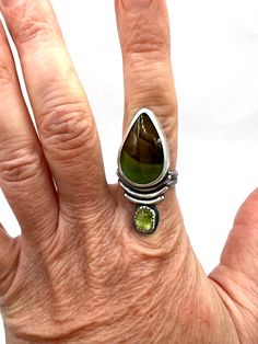 One of a kind, handcrafted Parnassus ring with ethically sourced stones of smooth turquoise & faceted peridot. It’s 1.65” tall. I named this style "Parnassus" because that is the mountain in Greece where literature and music and poetry were said to be born, and Ann Patchett named her bookstore after that. I was reading a book of hers while making this style (or rather after work, but the evenings when I both came up with this design & in between rests), so I wanted to name them in her honor beca Adjustable Green Multi-stone Ring, Artisan Green Multi-stone Jewelry, Unique Multi-stone Green Jewelry, Unique Green Multi-stone Jewelry, Green Oval Fusion Rings, Green Sterling Silver Fusion Gemstones, Green Peridot Rings With Nature-inspired Style, Green Multi-stone Healing Jewelry, Unique Green Peridot Rings